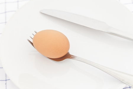Fresh eggs in white dish.