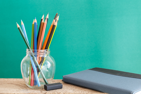 Educational Equipment on the student desk and the chalkboard background. Education Concept.の写真素材