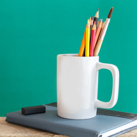 Educational Equipment on the student desk and the chalkboard background. Education Concept.の写真素材