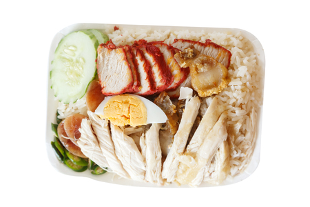 Rice steamed with chicken soup crispy pork roasted red pork and boiled egg.の写真素材