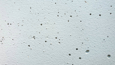 white concrete wall texture with holes. background and texture for design.の写真素材
