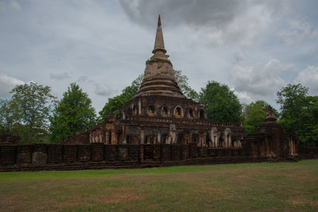 A large ancient pagoda made of brown bricks with a Buddha imageの写真素材