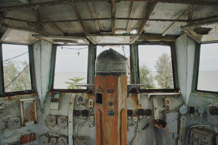 Inside the old boat control room There are windows in front and sides to see trees and seaの写真素材