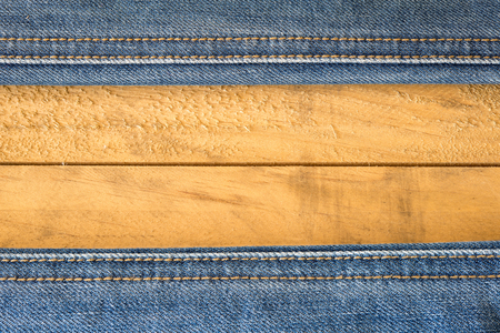 Seam of Blue Jeans on wooden Textureの写真素材