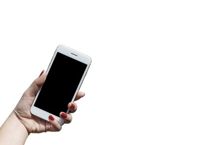 woman is holding a white mobile phone and has a white background.の写真素材