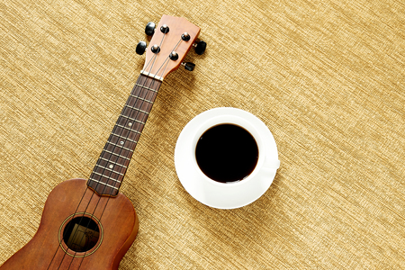 Top view with ukulele on the floor There are cup of coffee is placedの写真素材