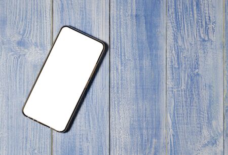 Smart phone on wooden table background with copy spaceの写真素材