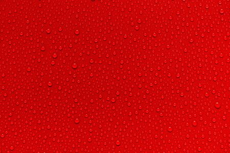 Water drops on red background.の写真素材