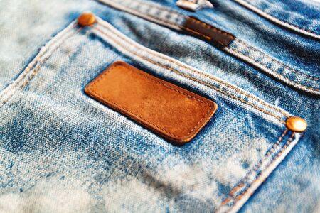 Selective focus and Soft focus / Close up of a blue jeans label. Blank jeans label to add textの写真素材
