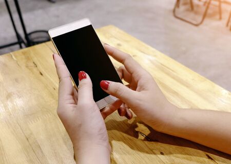 Woman hand holding mobil phone blank person smartphone cell. Black screen phoneの写真素材