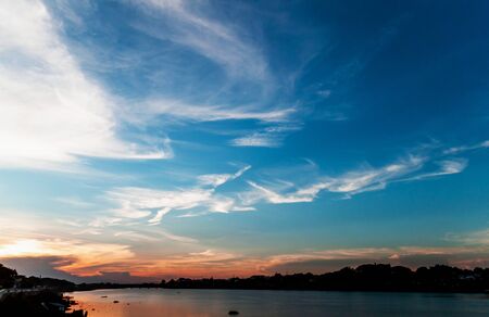 Beautiful sunset with clouds River view In the eveningの写真素材