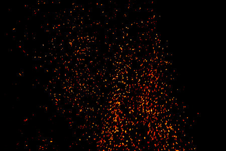 Abstract blaze fire flames. Fire flames with sparks on a black backgroundの写真素材