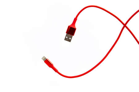 Red USB cable for smartphone isolated on white backgroundの写真素材