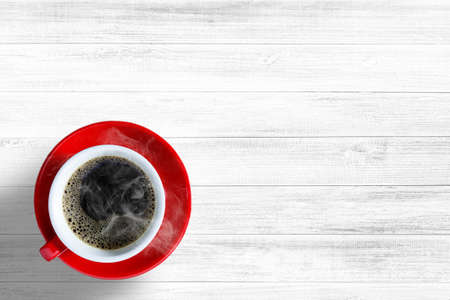 Red cup coffee on white wood table backdrop or wooden background, Top view, Concept For relaxingの写真素材