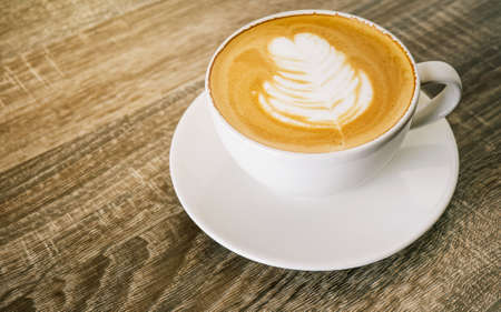 White coffee cup latte on wooden table in coffee shop, with empty space for text. concept relaxの写真素材