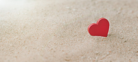 One Wooden Red Hearts On a sandy beach With a Sunlight, The Concept of Love and Couple. Valentine's Day Conceptの写真素材