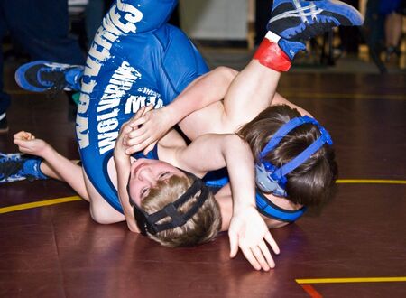 Marietta, Georgia - January 24, 2010 - Two young (10 year old) boys at the Cobb County Invitational Wrestling Tournament at Sprayberry Highschool.のeditorial素材