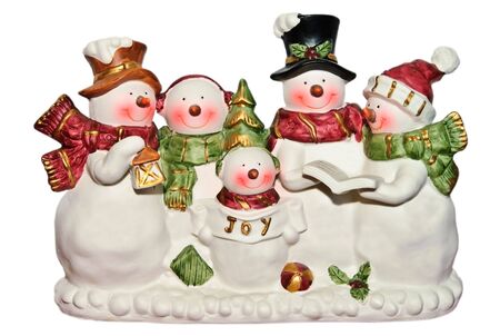 Cute happy snowmen and women and children figurines singing Christmas carols.の写真素材