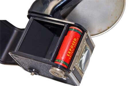 An old camera with the flash on the side. The back is open showing film inside.  Some day I'll have...