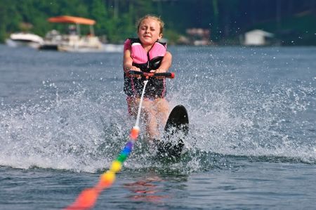 A young girl (8 years old) starting her slalom run behind a boat.の写真素材
