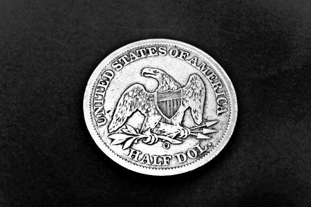 The back side of an American half dollar coin dated 1856, showing the eagle.  Black and white with halftone treatment.の写真素材