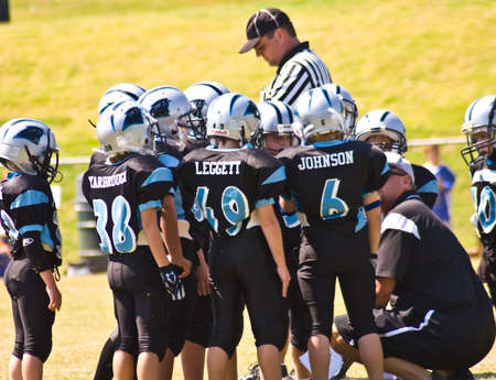 Cumming, GA, USA - September 20, 2008: A coach giving instructions to his team, the Panthers, in Forsyth County, Cumming, GA, September 20, 2008. のeditorial素材