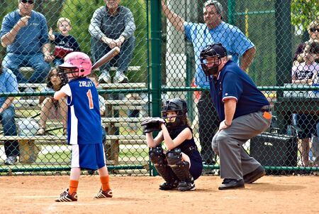 Cumming, GA, USA - April 18, 2009 : A young girl  at bat during a softball game. Forsyth County, Cumming, GA, April 18, 2009. A regular season game of the Lady Gators vs the Bennet Park Blues.のeditorial素材