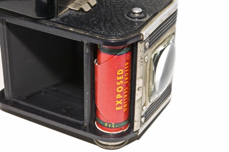 An anitque camera showing the exposed film inside.