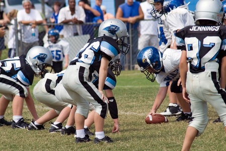 Cumming, GA, USA - September 15 -  A group of young boys on the field ready to make the snap.  Forsyth County, Cumming GA, September 15, 2007, a  recreation department little league football game, the Panthers vs War Eagles.のeditorial素材