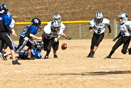 Cumming, GA, USA - November 8 : Group of young boys on the football field chasing a loose ball.  Forsyth County, Cumming, GA, November 8, 2008,  boys team of 8-9 year olds during a game, the Panthers and War Eagles.のeditorial素材