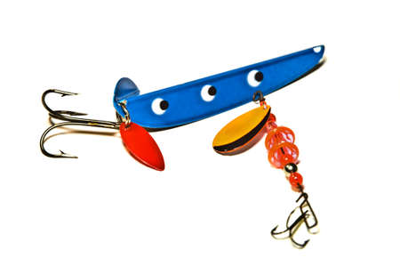 Brightly painted metal and rubber deep sea fishing lures with hooks.の写真素材