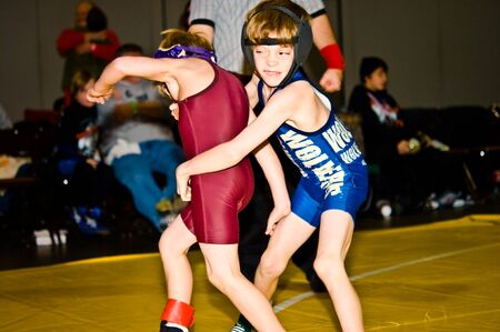 Atlanta, Ga USA - December 28, 2009 - Two young boys, under 10, wrestling at the Dixie Nationals Championship in Atlanta GA.のeditorial素材
