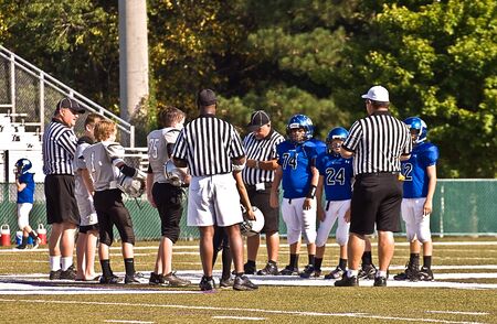 CUMMING, GA, USA - AUGUST 27: Unidentified players and officials together as pregame instructions are given to teams of 11 to 13 year-old boys, The Raiders vs The War Eagles on August 27, 2011 in Cumming GA. のeditorial素材