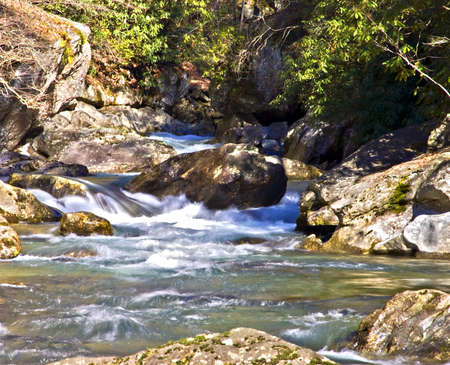 The Tallulah River with large rocks and Rhododendron blooming.の写真素材
