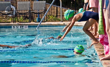  Atlanta,Georgia, June 28, 2012:Young swimmers at a competition swim meet entering the water for their lap. Lake Forest vs St. Marlo.のeditorial素材