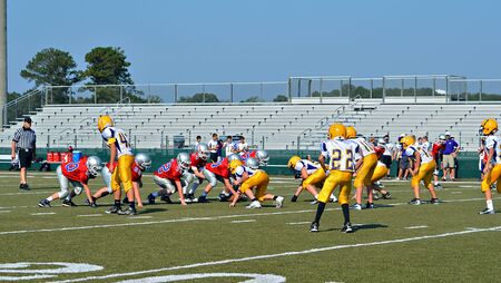 CUMMING, GA/USA - SEPTEMBER 22: Unidentified players and referee at the line during a football game of 7th grade boys September 22, 2012 in Cumming GA.  North Forsyth vs Lakeside.のeditorial素材
