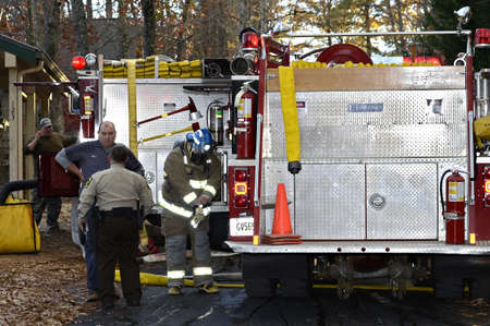 TIGER, GA, USA - NOV. 9: A group of firemen getting ready to fight a house fire. November 9, 2012,...