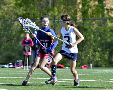 CUMMING, GA - APR 20: Newtown Eagles and West Forsyth Wolverines girl's lacrosse teams in a game on April 20, 2013 in Cumming, GA.のeditorial素材