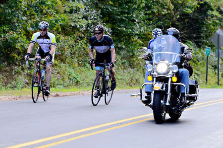 Dahlonega, GA, USA  September 29, 2013  Unidentified men being passed by a motorcycle in the Three and Six Gap Century ride  のeditorial素材