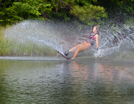 Young girl falling after a run on a course in a ski tournament の写真素材