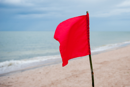 Red flag on the beach,Warning about the dangers.の写真素材