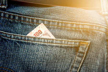 One hundred baht, in jeans pocketの写真素材
