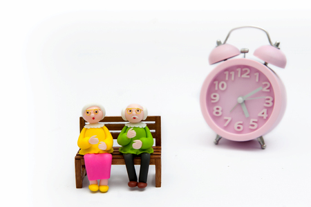 Old men and women with alarm clocks, ideas Fast forward timeの写真素材