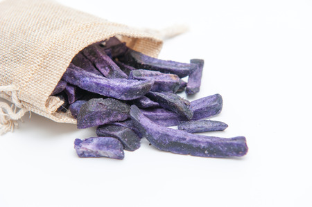 Purple potato chips, on a white background.の写真素材