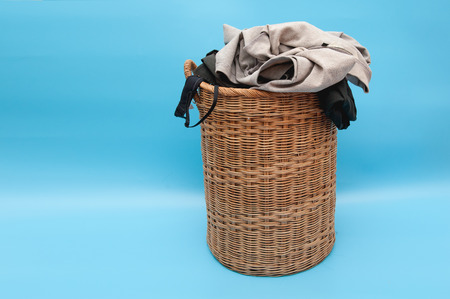 Wooden basket used for washing on blue floor.の写真素材