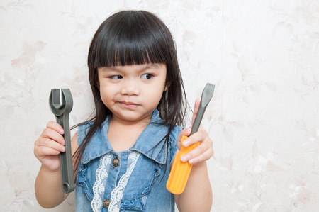 Girl is playing a repairman tool.の写真素材