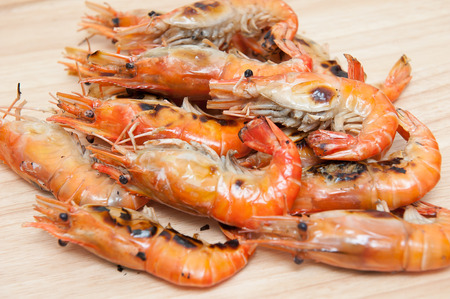 Grilled shrimp, fresh seafood, on wooden floorの写真素材
