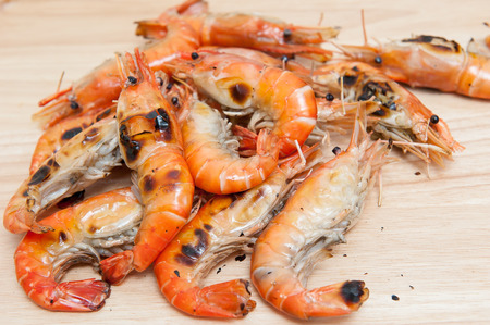 Grilled shrimp, fresh seafood, on wooden floorの写真素材