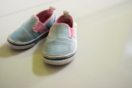 Baby shoes, placed on a beautiful floorの写真素材