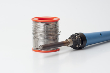 soldering iron soldering wire isolated on white background. (Soft focus, shallow DOF, slight motion...